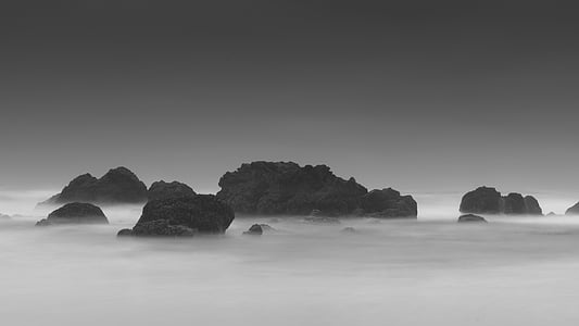 body of water with black stone rocks thumbnail