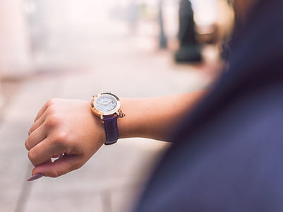 Person Wearing Round Gold Watch With Black Leather Strap thumbnail