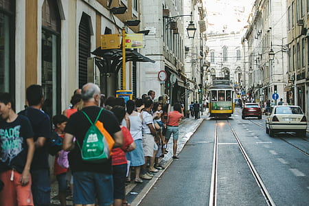 people standing beside road and building thumbnail