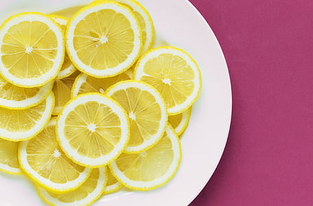 slices of yellow citrus fruits on white plate thumbnail