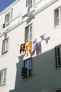 several clothes hanged on building thumbnail