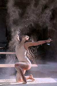portrait photography of woman in white monokini playing on white sand thumbnail