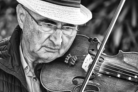 grayscale photography of man playing violin thumbnail
