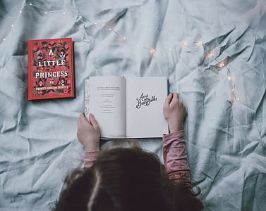 girl reading book inside room thumbnail