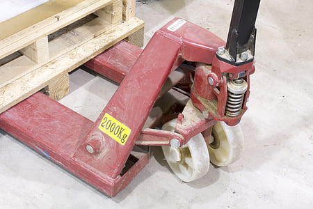 closeup photo of brown wooden pallet on red pallet truck thumbnail