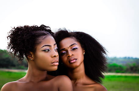 two ladies standing near green grass field thumbnail