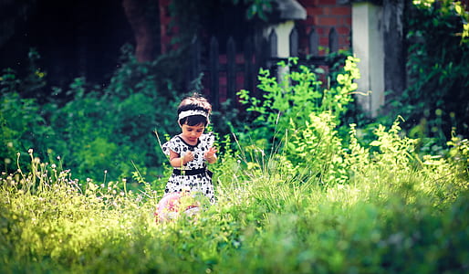toddler standing on green grass thumbnail