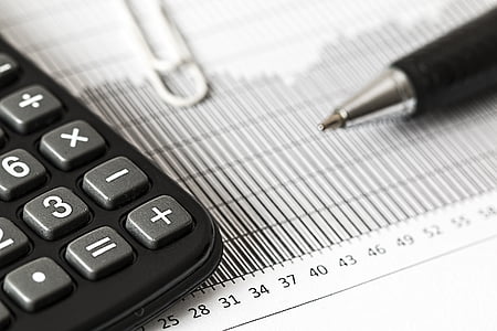 calculator and pen on white paper thumbnail