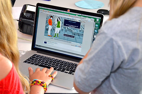 person in red top usin MacBook Pro thumbnail