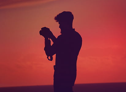 silhouette of man holding camera thumbnail