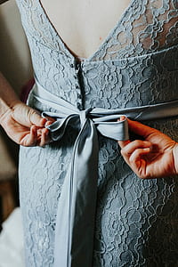 woman tying back ribbon dress thumbnail