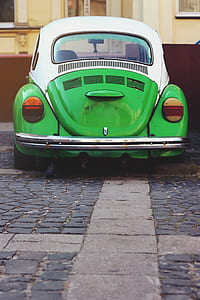 green and white Volkswagen Beetle Type 1 parked on roadside during daytime thumbnail