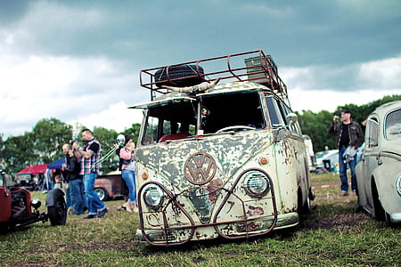 Volkswagen T-2 beside Beetle during cloudy weather thumbnail