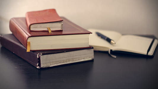 three assorted books on table thumbnail