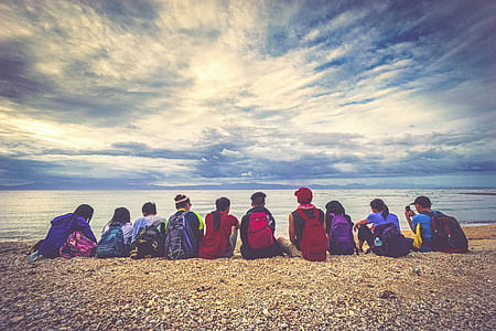 group of people in front of beach shore during daytime thumbnail