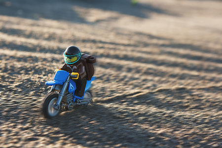 selective focus photography of minifig riding blue motorcycle thumbnail