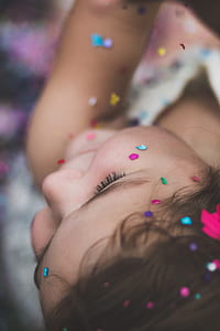 selective focus photography of girl with glitters thumbnail