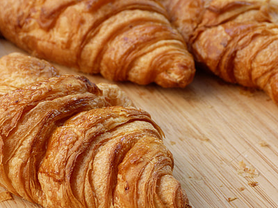 three croissant breads on brown surface thumbnail