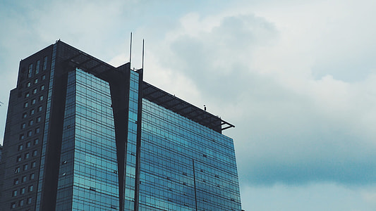 glass  building under cloudy sky thumbnail