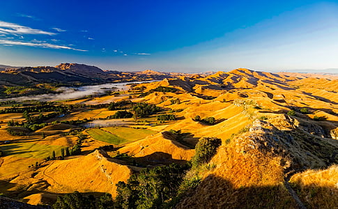 aerial view photography of grass field under calm clouds thumbnail