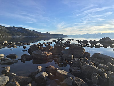 gray rocks on calm water during daytime thumbnail