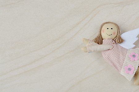 angel doll decor on beige surface thumbnail