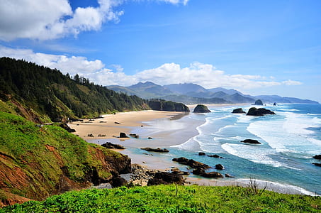 beach and rocky shores under blue sky thumbnail