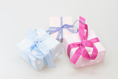 three assorted-color wrapped gifts on white surface thumbnail