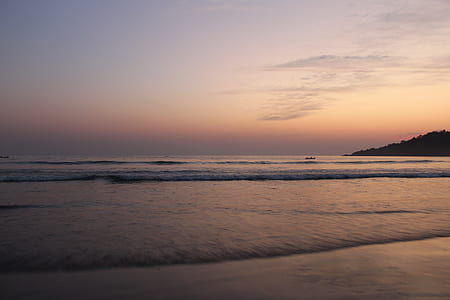 ocean under orange sky during sunset thumbnail