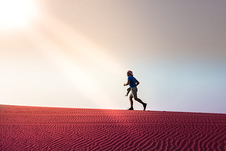 man running on desert during daytime thumbnail