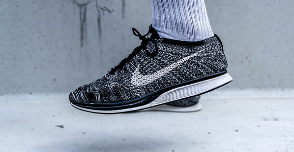 person wearing black-and-gray Nike low-top sneakers thumbnail