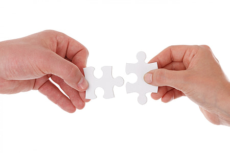 person holding 2-pieces jig saw puzzle thumbnail