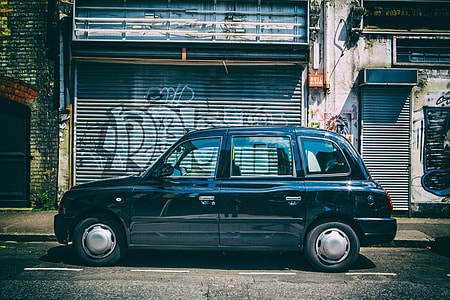 Wide-angle street shot of a black London taxi in East London, image captured with a Canon 5D DSLR thumbnail