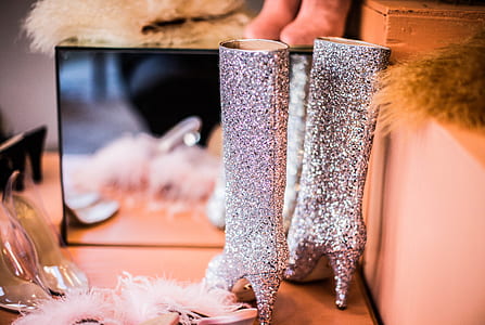 selective focus photo of gray glittered heeled knee high boots in front of mirror thumbnail