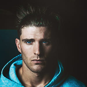 man wearing teal pullover hoodie thumbnail
