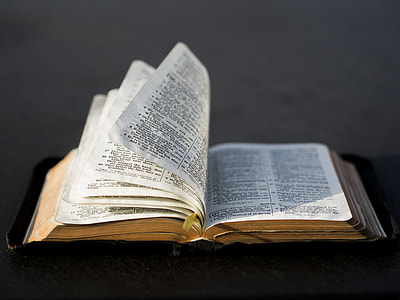 selective focus photography of open bible with black leather cover thumbnail