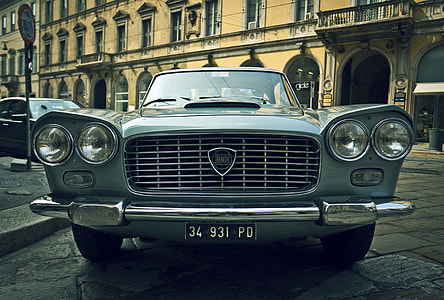 classic gray car parked near brown building thumbnail
