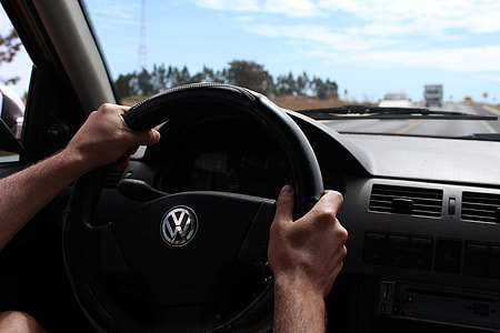 person driving Volkswagen vehicle at daytime thumbnail