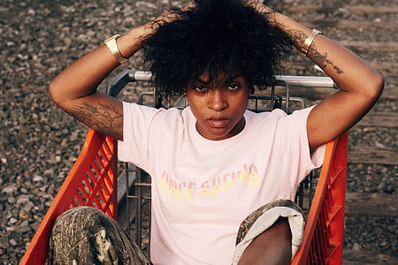 woman holding hair while sitting in shopping cart thumbnail