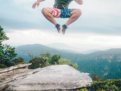 man jumping on top of cliff thumbnail