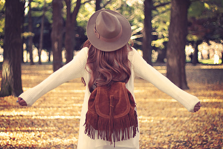 woman wearing brown sun hat and white sweater dress thumbnail