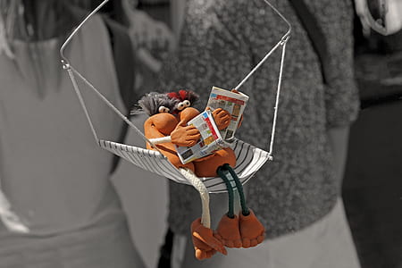 two brown characters on white and black swing reading magazines thumbnail