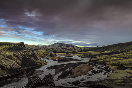 river surrounded by green mountains during daytime thumbnail