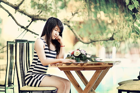 woman sitting on chair outside a restaurant thumbnail
