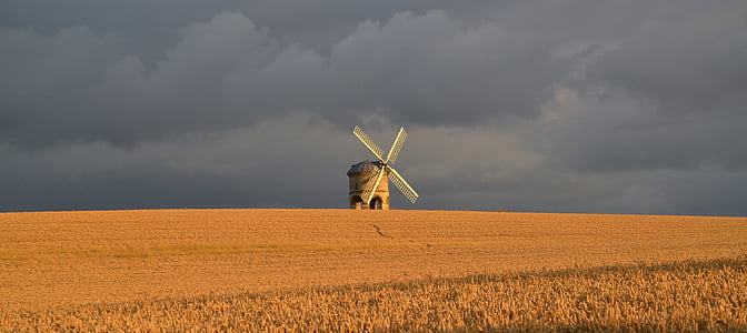 white wind mill on grass field thumbnail