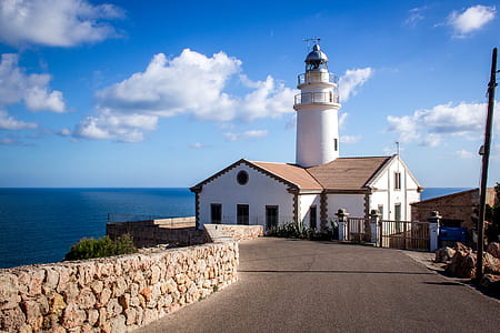white-and-brown lighthouse placed near sea thumbnail