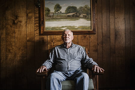 man sits near photo frame thumbnail