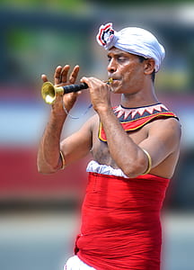 man playing brass flute at daytime thumbnail