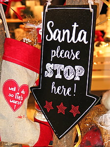 Santa Please Stop Here signage beside christmas stocking thumbnail