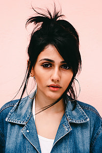woman in blue denim top wearing dangling earrings photography thumbnail